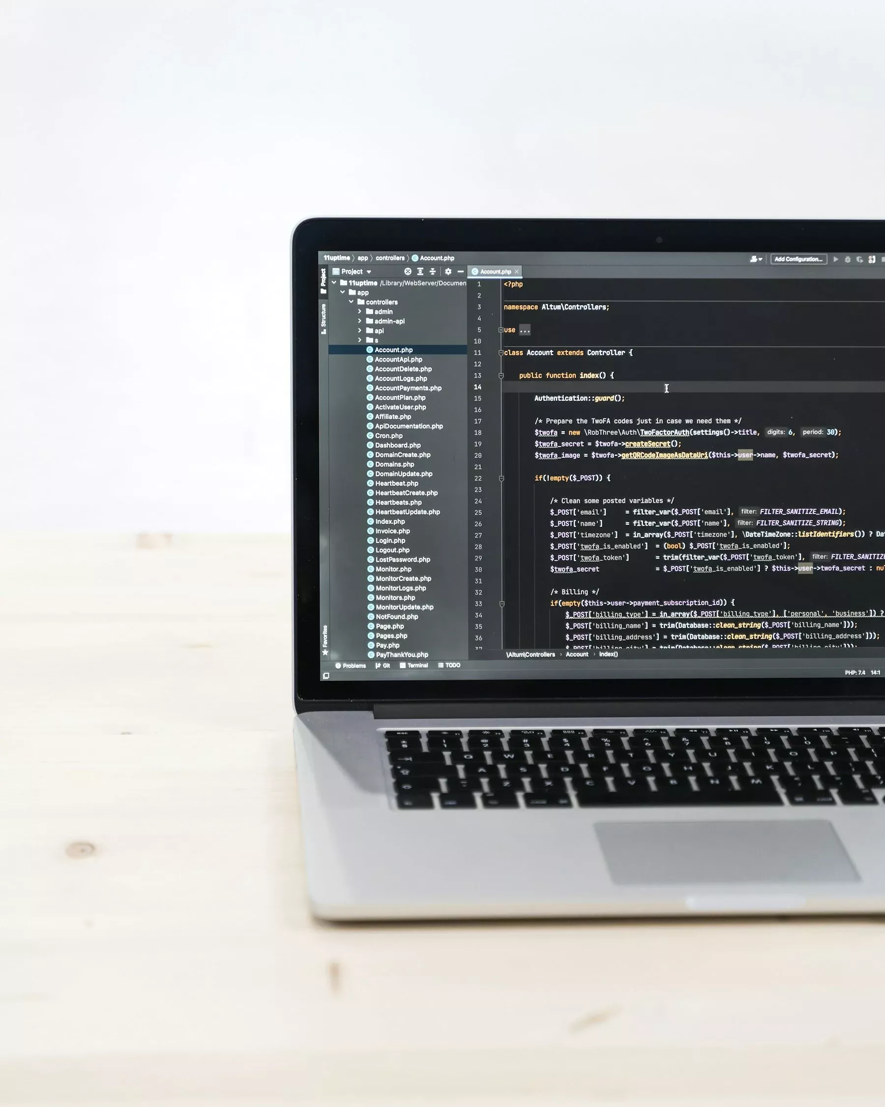 A laptop on a desk showing application source code in an editor